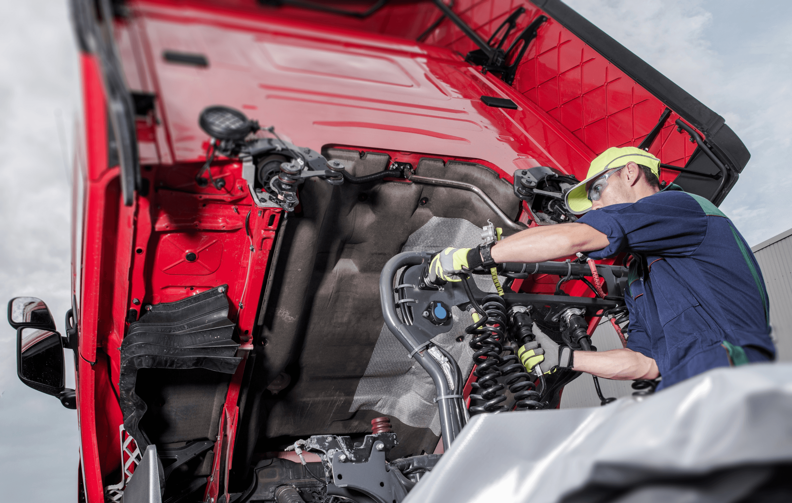 Professional truck mechanic working on engine